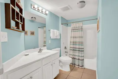 a bathroom with a white sink and a toilet at Seychelles 1609 in Panama City Beach