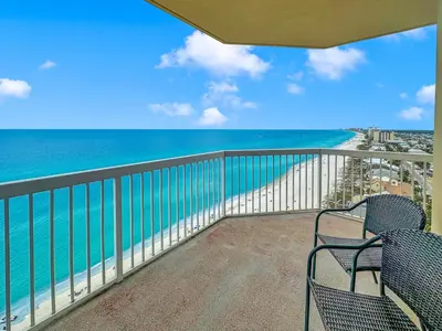 a balcony with two chairs and a view of the ocean at Seychelles 1609 in Panama City Beach