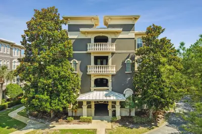 a large building with trees in front of it at 30A Sea View Villas by Panhandle Getaways in Santa Rosa Beach