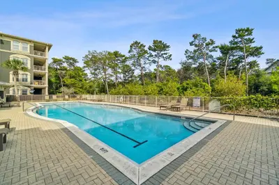 a swimming pool in front of a building at 30A Sea View Villas by Panhandle Getaways in Santa Rosa Beach