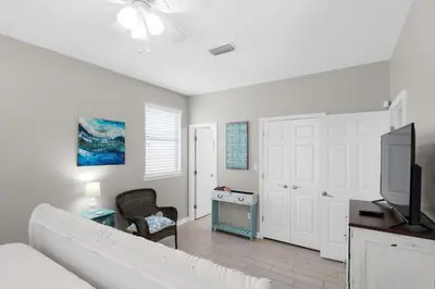a living room with a couch and a tv at Golden Shores in Panama City Beach