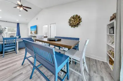 a dining room with a wooden table and chairs at Rustic Oasis in Panama City Beach
