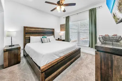 a bedroom with a bed and a ceiling fan at Rustic Oasis in Panama City Beach