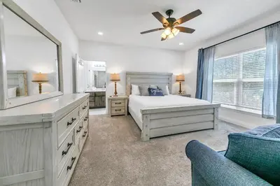 a bedroom with a bed and a ceiling fan at Rustic Oasis in Panama City Beach
