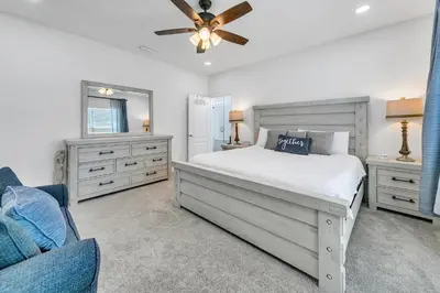 a bedroom with a bed and a ceiling fan at Rustic Oasis in Panama City Beach