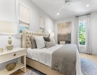 a white bedroom with a large bed and windows at Anchored on 30A in Santa Rosa Beach