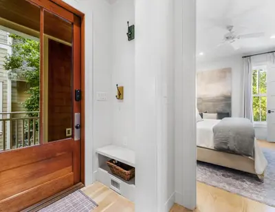 a bedroom with a bed next to a door at Anchored on 30A in Santa Rosa Beach