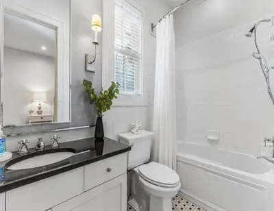 a white bathroom with a sink and a toilet at Anchored on 30A in Santa Rosa Beach