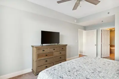 a bedroom with a bed and a tv on a dresser at Laketown Wharf #124 by Nautical Properties in Panama City Beach
