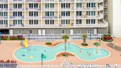 a large swimming pool in front of a large building at Laketown Wharf #124 by Nautical Properties in Panama City Beach