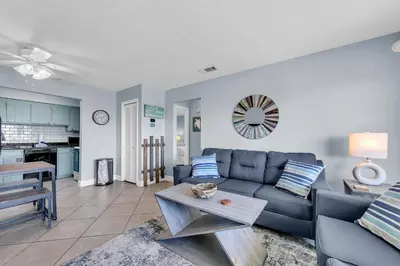 a living room with a couch and a table at Endless Summer A21 in Panama City Beach