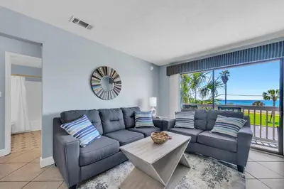 a living room with a couch and a table at Endless Summer A21 in Panama City Beach