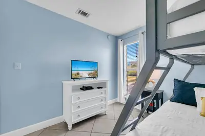 a bedroom with a bunk bed and a television at Endless Summer A21 in Panama City Beach