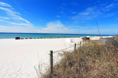 a fence on a beach with the ocean in the background at Endless Summer A21 in Panama City Beach