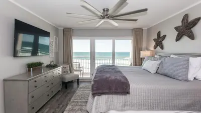 a bedroom with a bed and a ceiling fan at 5-STAR BEACHFRONT D505 - Total Remodel - Nov & Dec Snowbirds Welcome! in Panama City Beach