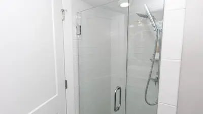 a bathroom with a shower with a glass door at 5-STAR BEACHFRONT D505 - Total Remodel - Nov & Dec Snowbirds Welcome! in Panama City Beach