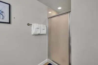 a shower with a glass door in a bathroom at Shores of Panama 1802 in Panama City Beach