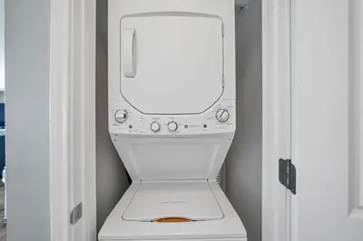 a white washer and dryer in a room at Shores of Panama 1802 in Panama City Beach